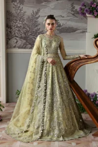 Model wearing pista green formal lehenga choli for wedding walima party wear